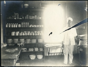 Unidentified African-American man standing in food preparation area.