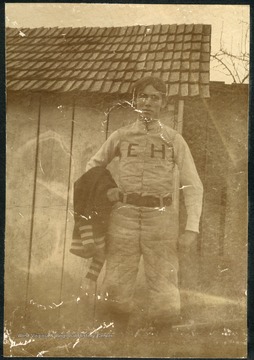 Unidentified student wearing a uniform with "EH" for Episcopal Hall.  