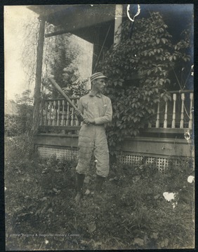 Unidentified player in a batting stance outside Episcopal Hall.