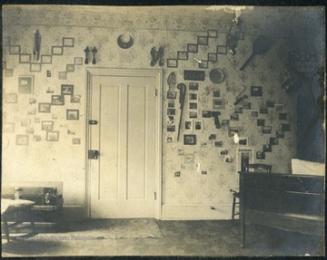 Dorm room walls are full of photographs and memorabilia. 