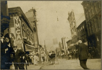 Busy scene in downtown Grafton. YMCA (Young Men's Christian Association) sign on the left side on the street. All persons in the photograph are unidentified.