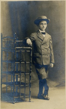 A young boy (most likely 9 or 10), wearing a suit and a hat. 