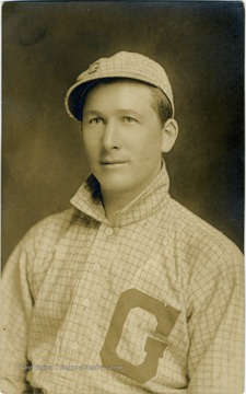 Young man wearing a baseball uniform with a large letter "G" on the shirt. 