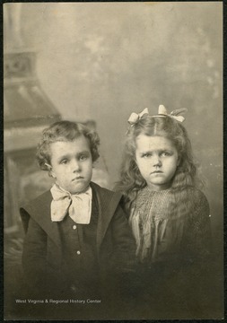 A young boy and girl, probably brother and sister.
