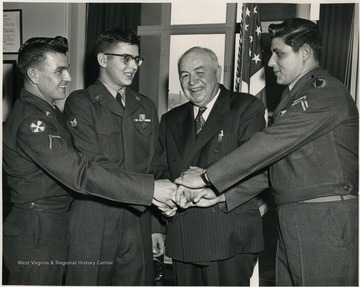 Inscription on the back includes; "Secretary of the Army Wilber M. Brucker presented Soldier Metal to the following U. S. Army military men in ceremony at the Pentagon, Washington, D. C. for their heroic actions following the crash of a commercial airlines near Seattle, Washington on November 18, 1955. Left to right, Pfc Reginald A. Layoff, Chicago, Illinois; Specialist Third Class Peter P. Tamburin, Wheeling, West Virginia; Senator H. M. Kilgore, West Virginia and Specialist Third Class Hugo W. Weiss, New York, N. Y." 