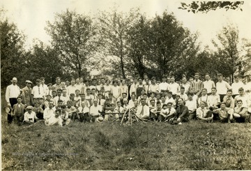 Inscription with the photograph:"A group of University High School boys and faculty men cleared underbrush from new school site. The girls served refreshments." Names included under the photograph: Dorsey, Calvert, Hill, Clark, Deahl, Stample, Federer, and Colebank. All other persons are unidentified. 