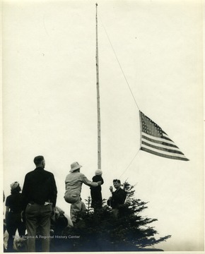 Members of the Porte Crayon Memorial Society, raise a flag on the peak of Mt Porte Crayon, honoring David Hunter Strother of Martinsburg, W. Va. Strother, known by his pen name "Porte Crayon", was a famous 19th century artist, writer, explorer, Civil War soldier and diplomat. Identified in the photograph are center left to right: Jack Preble, three year-old David Hunter Strother IV and Porter Strother,(Porte Crayon's great-grandson and grandson).