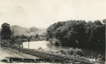 Postcard photograph of the train track running along the river outside of Belington.
