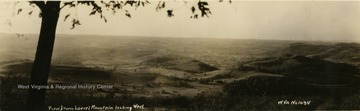 Oversized postcard. Most likely the town of Belington in the background.