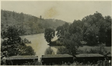 The Tygart River on the left and the West Fork on the right, flow together forming the Monongahela River. A loaded coal train can be seen in the foreground.