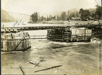 Make-shift piers in the Cheat River, support rail tracks used to transport supplies to the site. 