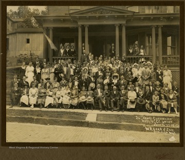 Group portrait of several men. women and children. None are identified.