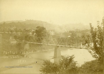 Information included with the photograph, "Note the bridge [crossing the West Fork River], does not have sidewalks. The flood of 1888 had washed out the middle pier which was restored by the late Charles L. Watkins. Steeple of Methodist Protestant Church can be seen."