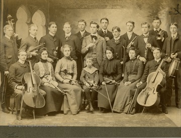Several unidentified WVU students, among others pose for a group portrait holding their instruments.