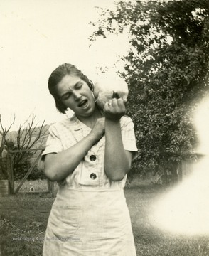 Marie Fansler with her chicken sitting on her shoulder.