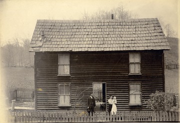 The Barr family posed in front of their two-store home.