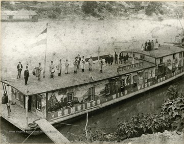 Several unidentified musicians and people pose on top of Captain Ellsworth Eisenbarth's Showboat. 