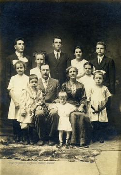 Pictured with their ten children: Harry, Lance, Kate, James, Jane, Mary, Anna, Sophie, Howard, and Eva.