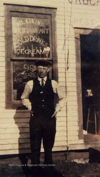 Unidentified man stands outside of the W.L. Elkins Restaurant.