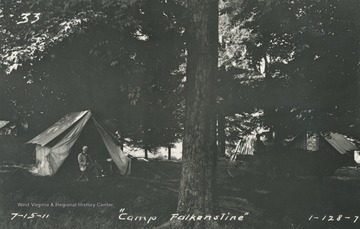 Unidentified man sits in front of a tent. This is possibly Samuel Gannett, commissioned to survey and set markers on the boundary line.