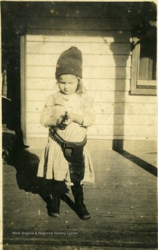 Young daughter of John Ball, wearing a holstered revolver. 