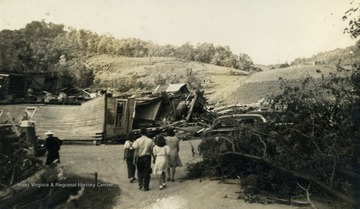 Family observes the destruction caused by the deadliest tornado in West Virginia's history which killed sixty-six people in the town and surrounding area.