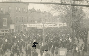 Banner over the road in photograph reads: "For The Good Roads Amendment November 2nd".