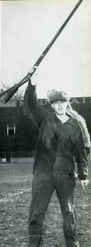 Thompson raises his musket while standing on old Mountaineer Field.