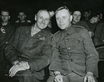 Information on back of photo reads: "Colonel H.A. Forlong (left) of Pontiac, Michigan, Surgeon of the 18th Corps, Ninth U.S. Army, sits beside a Russian Army officer at a stage show given in Lippstadt, Germany, May 20, 1945, by liberated Russian soldiers and former slave workers. Lippstadt is 70 miles northwest of the Rhine River city of Duisburg.