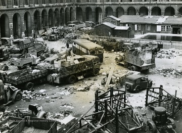 Information back of photo reads: "Looking down on some of the wrecked and abandoned Nazi equipment left in the courtyard of the City Hall in the 10th District of Paris after the French capital's liberation August 25, 1944. The Nazis used the building as a telephone center and fortress. Their resistance was strong here and many members of the Maquis were massacred and buried in the courtyard."