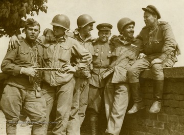 Information on back of photo reads: "Firm contact has been established between ground forces of the First American Army and those of the Russian Army. The historic meeting took place in the town of Torgau, on the Elbe River, 75 miles south of Berlin, when First Army troops met forward elements of the Russian Guards Division."