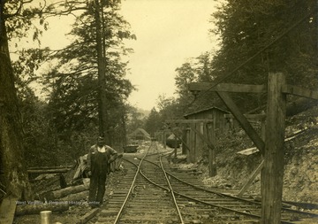 Worker stands beside railroad tracks around the Rich Run Mine in Widen, W. Va.