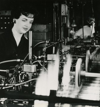 Caption on photo reads: "Pharmaceutical vials are shown undergoing cutting and fire polishing at Parkersburg, West Virginia plant of Corning Glass Works."