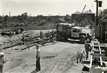 Built in the wake of the devastating Flood of 1937, when the Ohio River crested at more than 19 feet above flood stage at Huntington. The flood wall was built in 3 separate sections. Shown here is the Guyandotte section under construction.