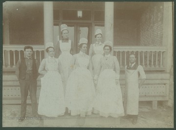 Unidentified members of the staff pose on the porch of the hospital.