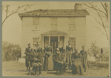 Included in the photograph taken outside the family home: Mr and Mrs William Hibbs; Arizona Hibbs; Effie Hibbs; Carrie Hibbs; Mattie Hibbs; Millie Hibbs; Ida Hibbs; and Samuel Roderick, grandfather.
