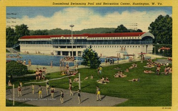 People can be seen playing volleyball, sun tanning, and swimming in the pool outside of the recreation center. See original for correspondence. Published by Huntington News Agency. (From postcard collection legacy system.)