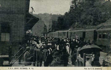 Travelers wait to board arriving train. Published by C.E. Armstrong. (From postcard collection legacy system.)