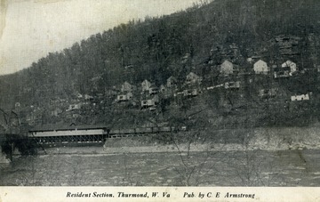 Homes of residents of Thurmond, West Virginia on the side of the mountain above railroad tracks. Published by C.E. Armstrong. (From postcard collection legacy system.)