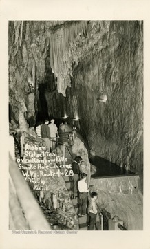 Visitors observe the stalactites that cover the Smoke Hole Caverns. (From postcard collection legacy system.)