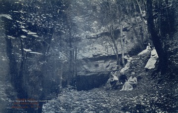 A small group rests on the hill by Organ Cave. See original for correspondence. (From postcard collection legacy system.)