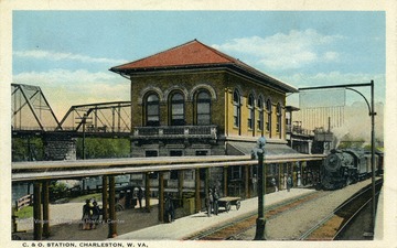 People await the oncoming train outside of the C. &amp; O. Station. (From postcard collection legacy system.)