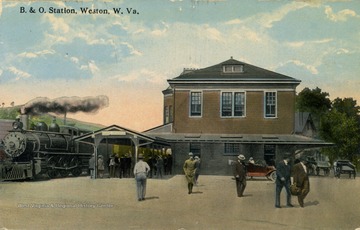 People wait to board the train outside of the Baltimore and Ohio Railroad Station. (From postcard collection legacy system.)
