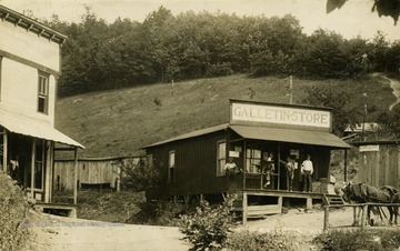 Four men stand on the front porch of the Galletin Store. (From postcard collection legacy system.)