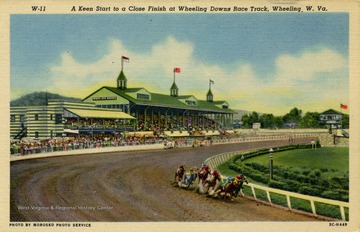 Closely contested horse race around bend at Wheeling Downs Race Track. Published by Phillips News Company. (From postcard collection legacy system.)