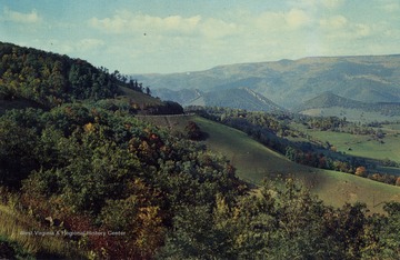 Caption on back of postcard reads: "This view shows curve in highway below with Spruce Knob in the distance overlooking Old Seneca Trail or Warrior's path. Germany Valley and the Smoke Hole are to the right." Published by Valley News Agency Incorporated. (From postcard collection legacy system.)