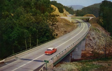 Caption on back of postcard reads: "Bridge over Milburn Creek is one of 76 bridges on West Virginia turnpike." Published by Mike Roberts Color Production. (From postcard collection legacy system.)
