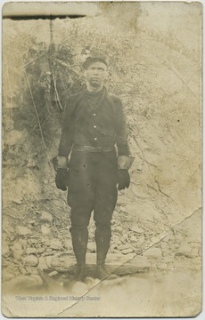 Miner, outfitted in mining work clothes and equipment, poses for photograph.(From postcard collection legacy system--subject.)