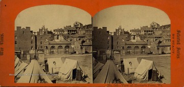 Armory Engine House and John Brown's Fort seen in background. Army tents pitched in the foreground. Photograph was taken during the Civil War.