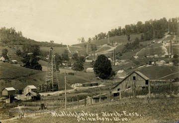 Various oil wells can be seen spread through the hillside. See original for correspondence. (From postcard collection legacy system--subject.)